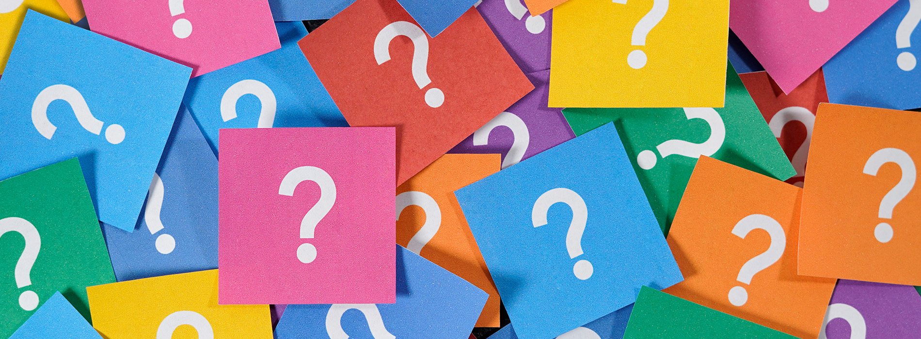 The image shows a collection of colorful sticky notes with question marks on them, arranged in rows against a neutral background.