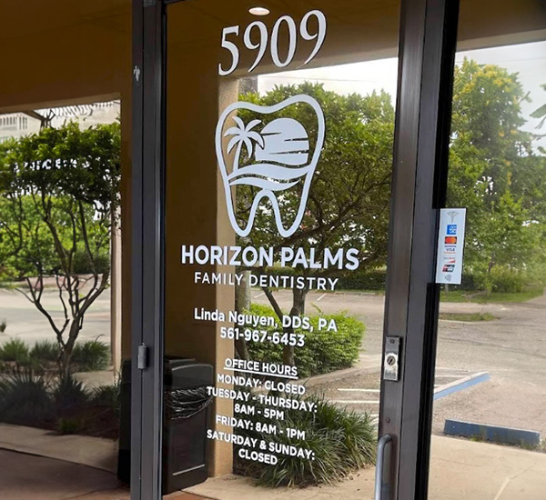 The image shows the entrance to a dental practice named  Horizon Palms Family Dentistry,  with an address sign indicating  6909  and a phone number visible, along with a logo that includes a palm tree and a stylized toothbrush.