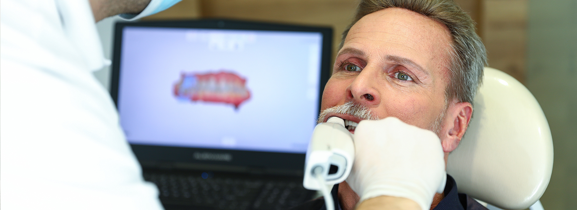 A man receiving dental care with medical equipment around him.